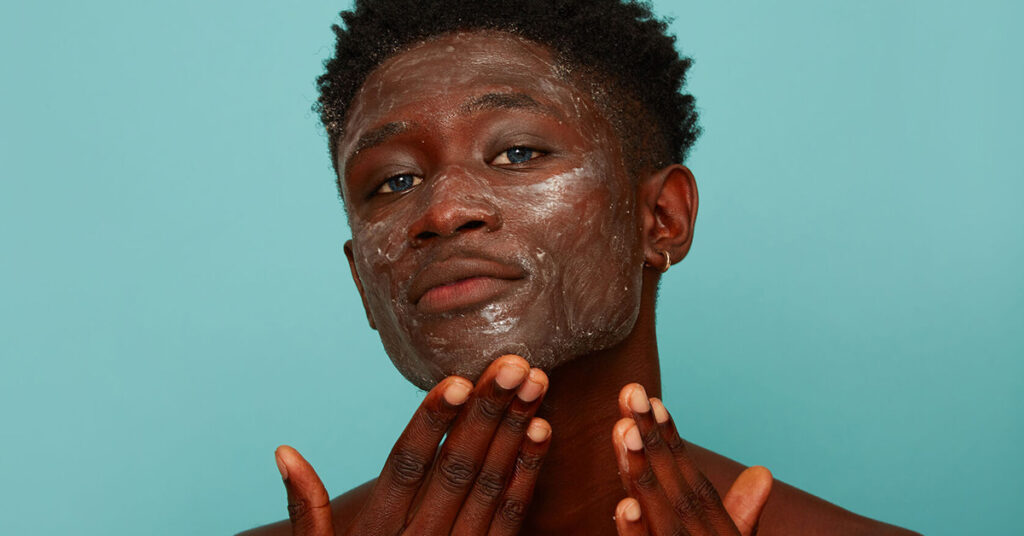 Man exfoliating his skin, skincare for men, dry skin